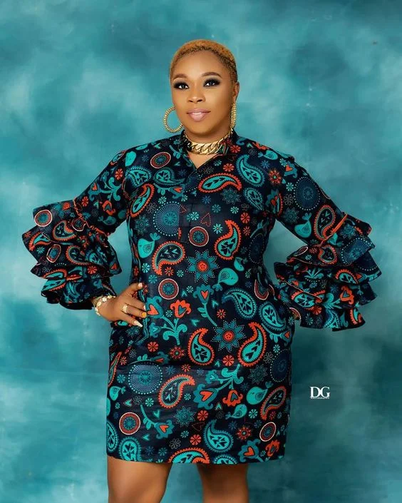 Ankara Gown Styles for Plus-Size Ladies in 2023: A chic model wearing The Shift Ankara Gown with bold African prints, showcasing the timeless elegance of African fashion.