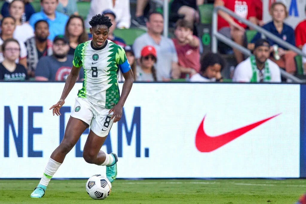 Asisat Oshoala, a prominent Nigerian female footballer, showcasing her unparalleled agility and precision on the pitch, significantly enriching Nigerian sports.