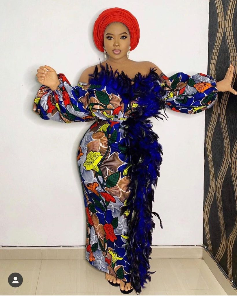 A stunning model elegantly showcases The Balloon Sleeve Ankara Gown, featuring intricate African patterns and a unique silhouette, embodying the charm of African couture.