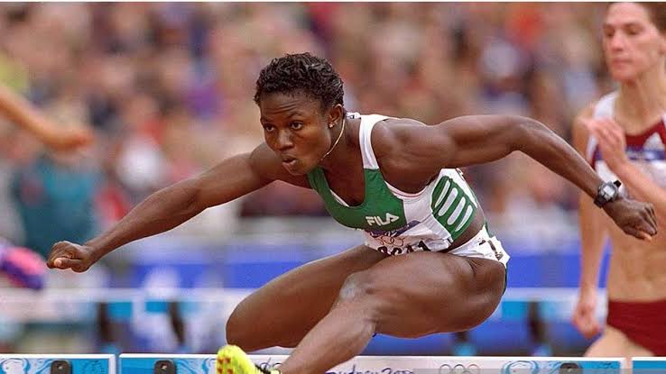 Gloria Alozie, an outstanding Nigerian female athlete, displaying her remarkable speed and agility in a high-stakes track and field event.