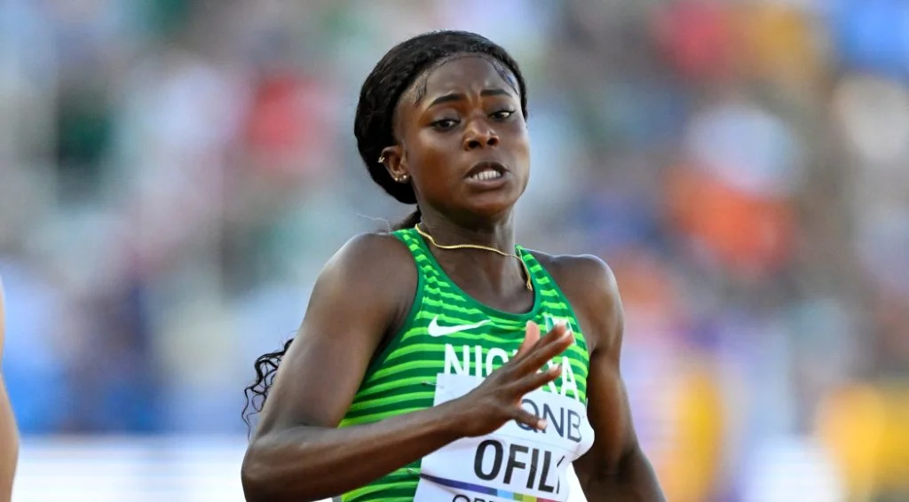 Favour Ofili, a dynamic Nigerian female track and field athlete, displaying her exceptional speed and tenacity during a thrilling competitive event.
